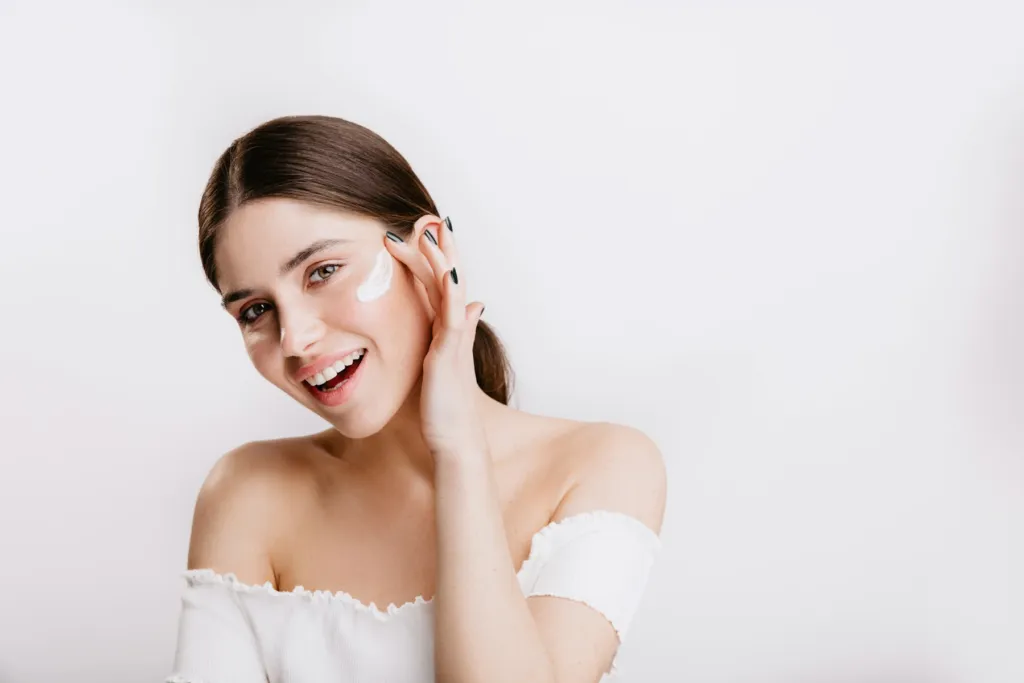 Smiling woman touching her healthy skin